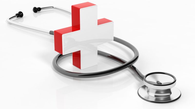 Medical cross with stethoscope isolated on white